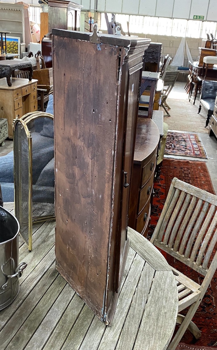 A George III oak hanging corner cupboard, width 58cm, depth 29cm, height 87cm